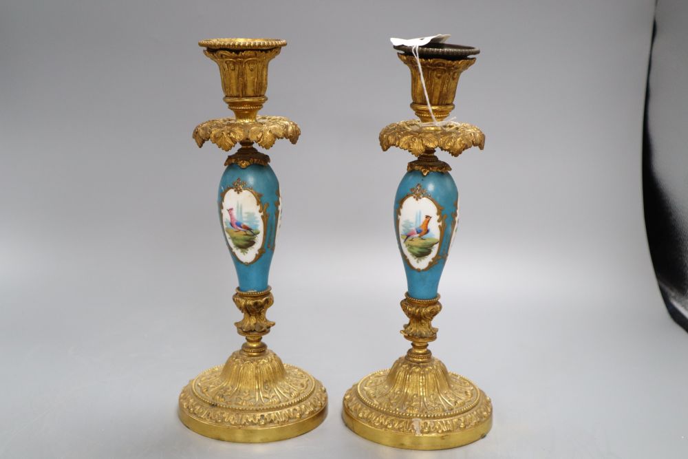 A pair of French gilt metal and porcelain candlesticks, height 27cm